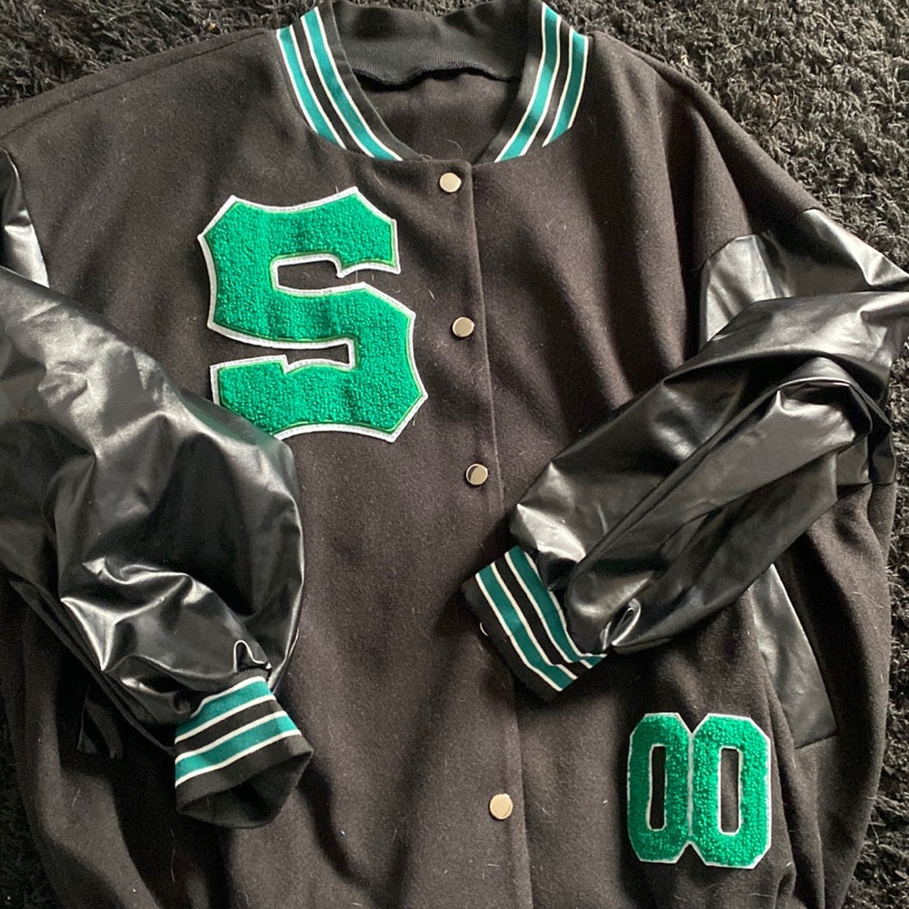 Green letterman’s jacket